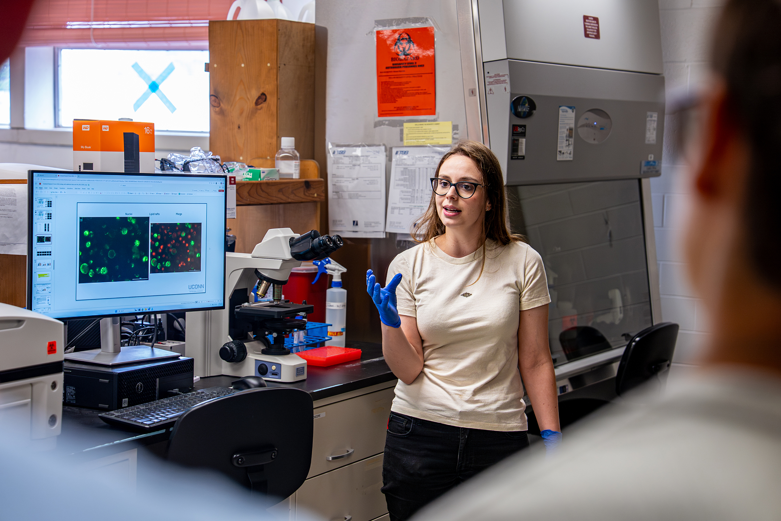researcher explaining data in a lab